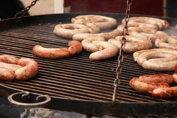 Street food process of frying sausages on the open fire