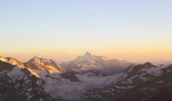 Panorama of mountain peaks in the setting sun, the majesty and b