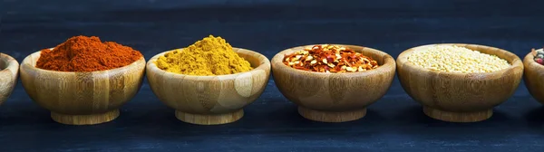 Spices powders and seeds in bamboo bowls
