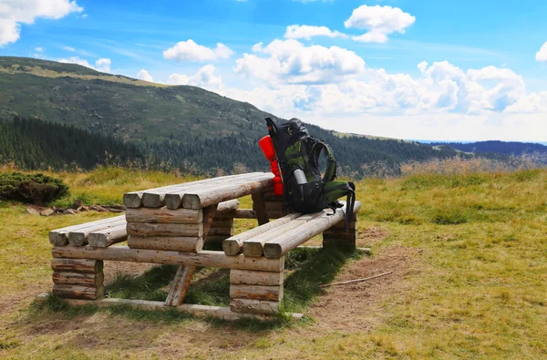 Mountain backpack on wooden camping table