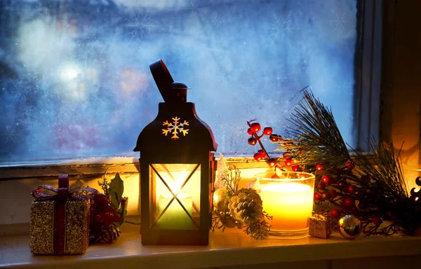 Warm Lantern on Frozen Window with Decoration