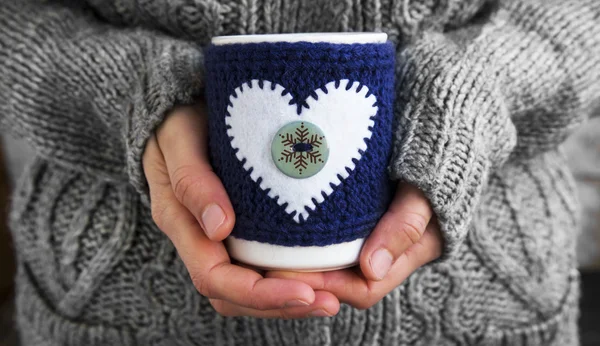 Female Holding Coffee Mug with Wool Knitted Cloth with Heart Sha