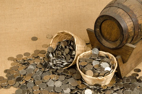 Stack of coins with wooden barrel