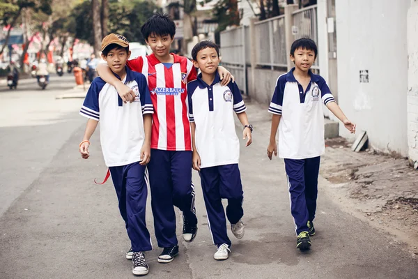 Unidentied boys walking on street  in Ho Chi Minh