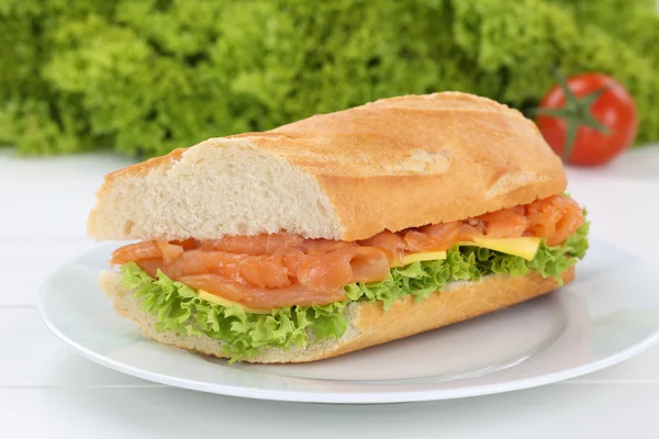 Sub sandwich baguette on plate with salmon fish for breakfast