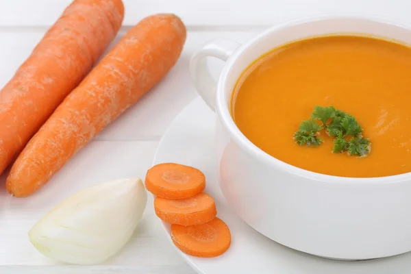 Carrot soup with carrots in cup
