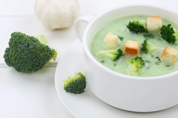 Fresh broccoli soup in cup closeup