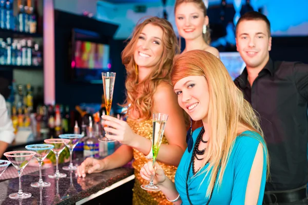 People in club or bar drinking champagne