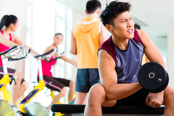 People exercising sport for fitness in gym