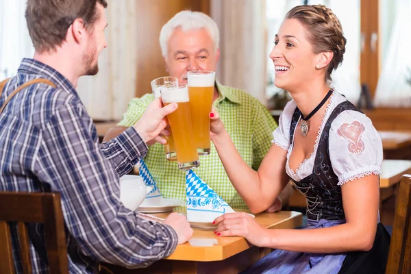 People drinking wheat beer in bavarian restaurant