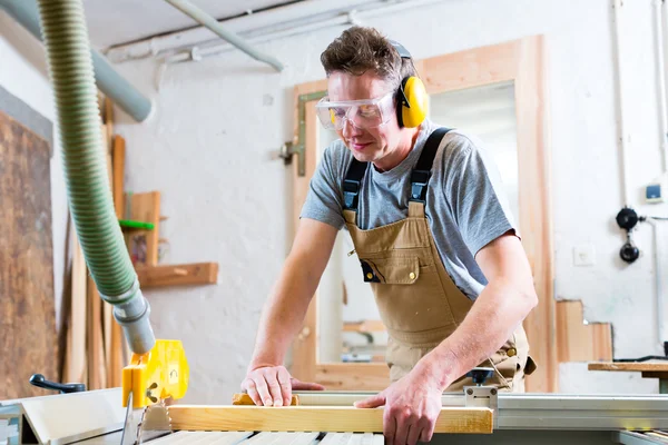 Carpenter using electric saw in carpentry