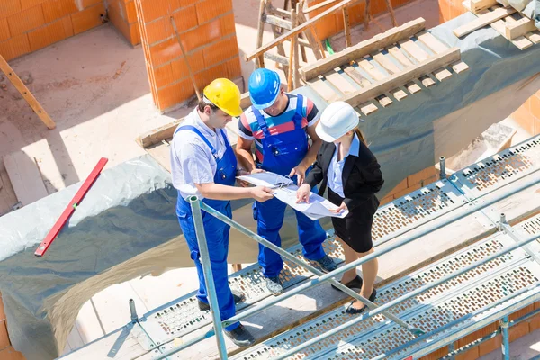 Team discussing construction or building site plans