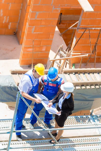 Team discussing construction or building site plans