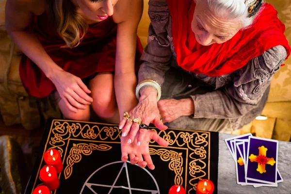 Soothsayer during a session doing palmistry