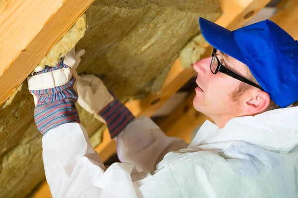 Worker setting thermal insulating material