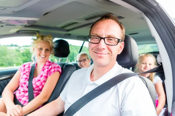 Family driving in car with seat belt fastened