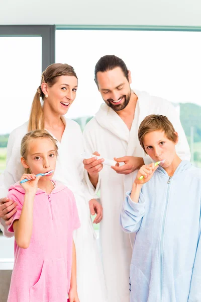 Family at dental care routine in bathroom