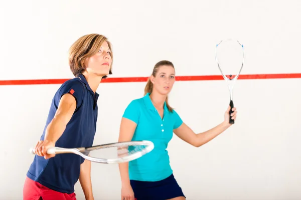 Squash racket sport in gym, women competition