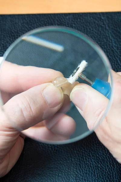 Acoustician working on a hearing aid