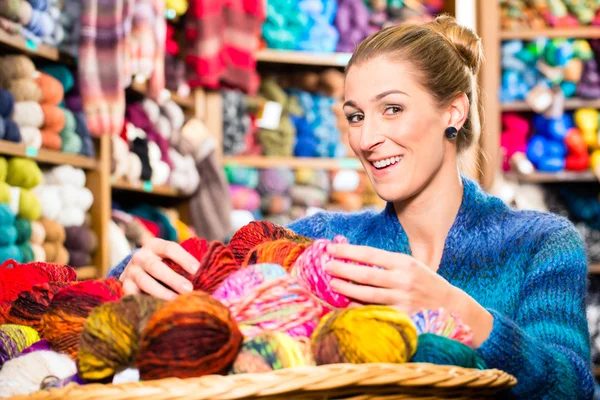 Young woman in knitting shop