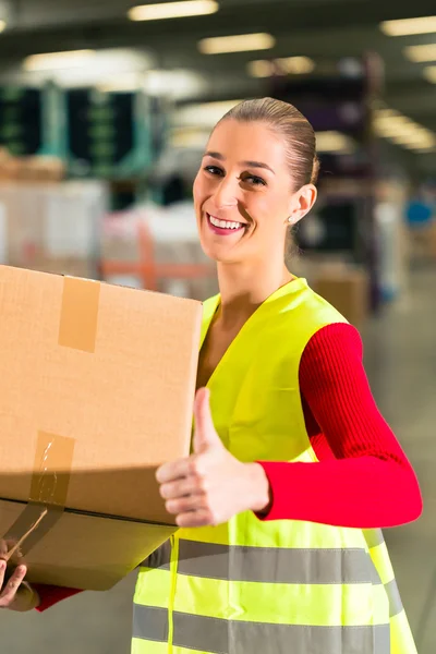 Worker holds package in warehouse of forwarding