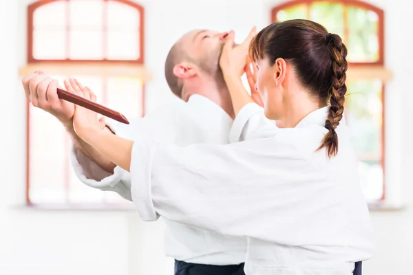 Man and woman having Aikido knife fight