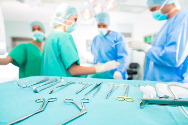 Surgeons operating patient in operating room