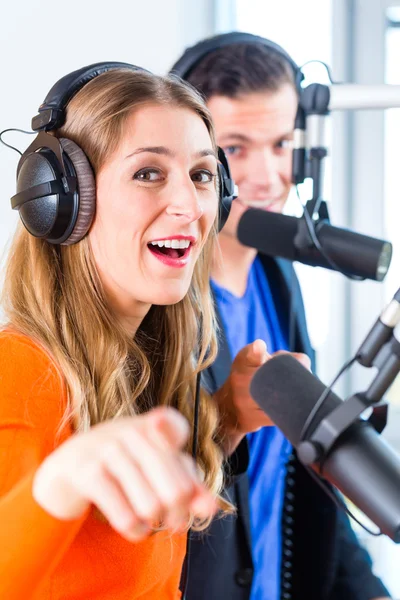 Radio presenters in radio station on air