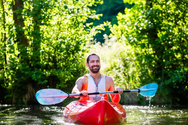 Man paddling with kayak on river for water sport