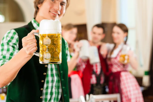 People in traditional Bavarian Tracht in restaurant or pub