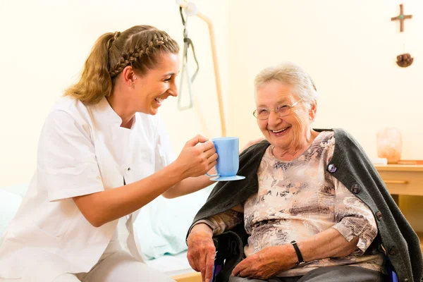 Nurse and female senior in nursing home