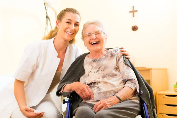 Nurse and female senior in nursing home