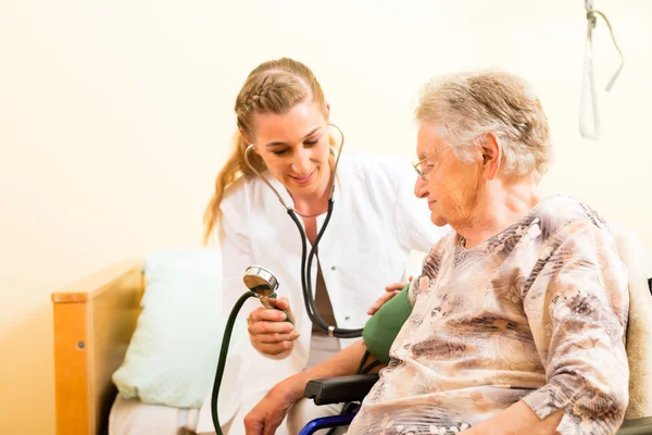 Nurse and female senior in nursing home