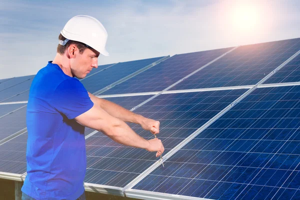 Technician maintaining  solar panels
