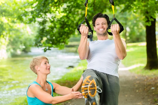 People doing suspension or sling trainer fitness
