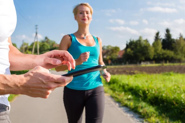 Couple running, sport jogging on rural street