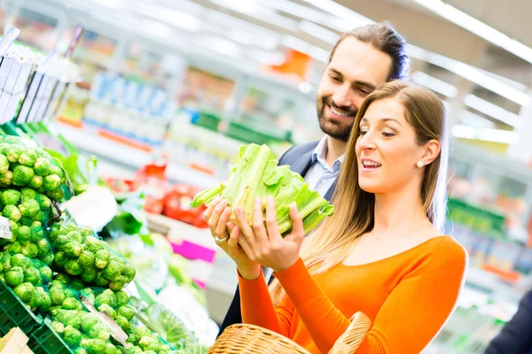 Couple shopping groceries in supermarket