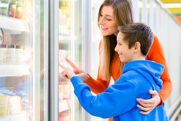 Family selecting cooled products in hypermarket