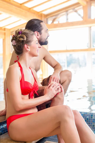 Couple relaxing together at wellness spa pool