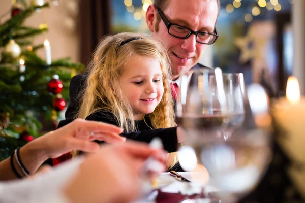 Family eating Christmas dinner at home