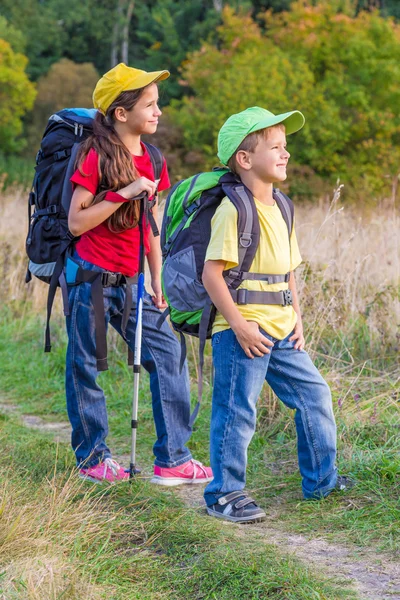 Two traveling kids with backpacks