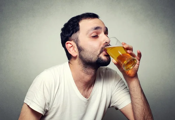 Funny bearded man drinking beer