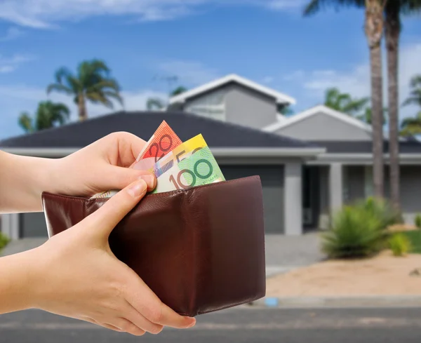 Australian money in wallet on real estate background