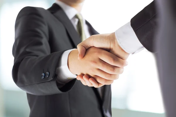 Business and office concept - businessman shaking hands