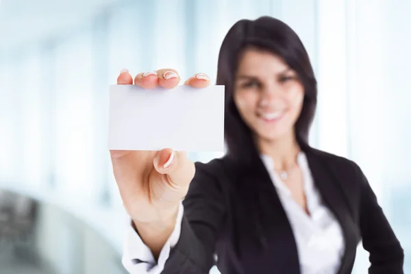 Young, attractive, successful business woman shows business card