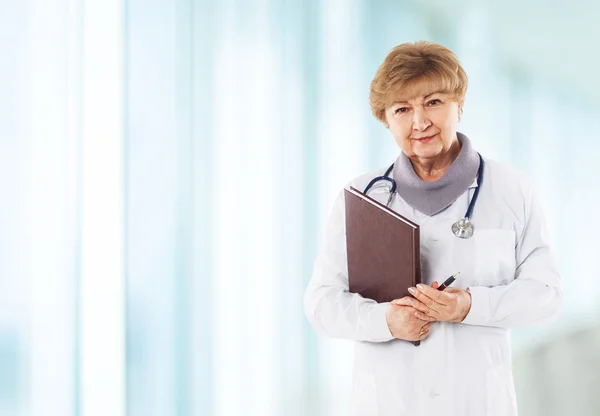 Medical physician doctor woman over blue clinic background