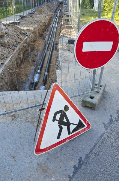 New heating system pipes and road signs on street