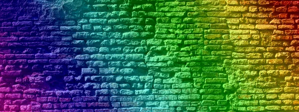 Concept or conceptual colorful painted or graffiti old vintage grungy brick wall texture or urban background banner
