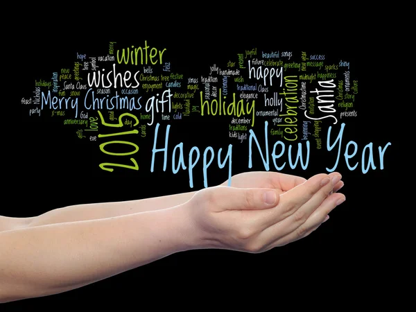 Concept or conceptual Happy New Year 2015 or Christmas abstract holiday text word cloud held in hand isolated on background
