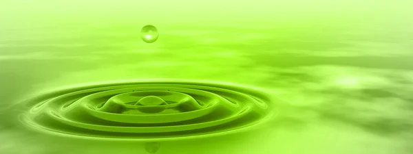 Concept or conceptual green liquid drop falling in water with ripples and waves background banner